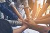 Group of people touching hands