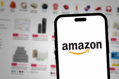 Amazon logo on phone against website background
